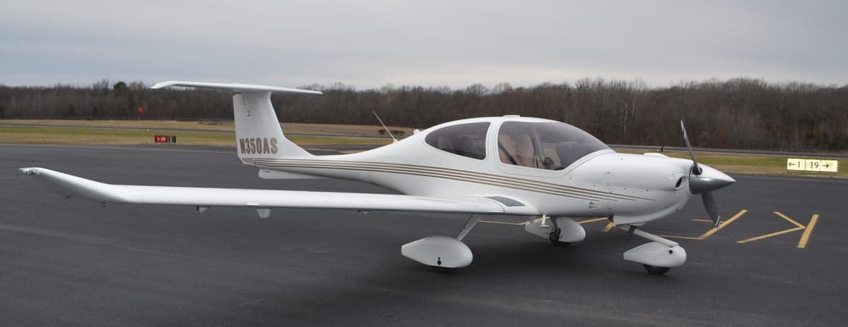 A Diamond DA40 aircraft with registration N350AS, parked on the tarmac.