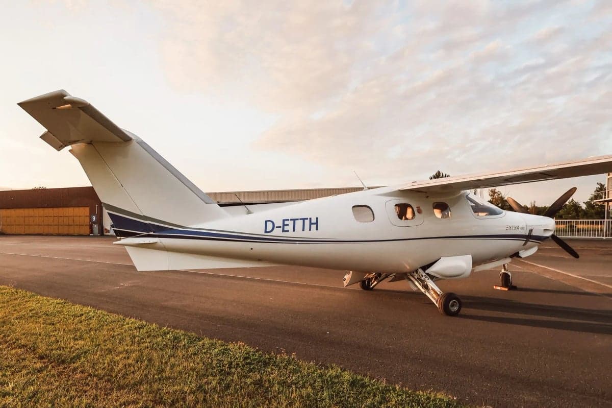 Side view of the Extra 400 aircraft D-ETTH on the ground.
