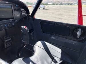Interior view of the Cubcrafters XCub cockpit, showing the seat, side panel, and instrument panel.