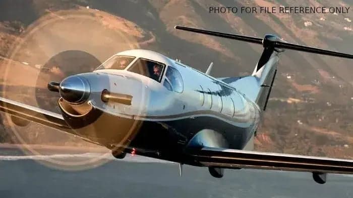 A Pilatus PC-12 in flight with a close-up view of the cockpit.