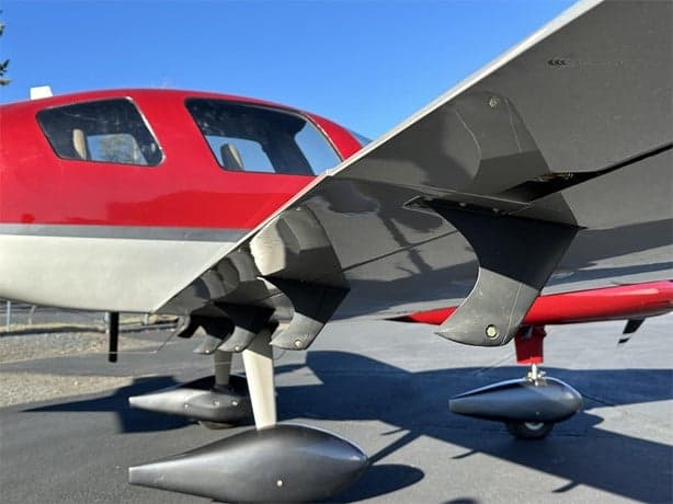 Close-up of the wing and landing gear of the LX7 aircraft.