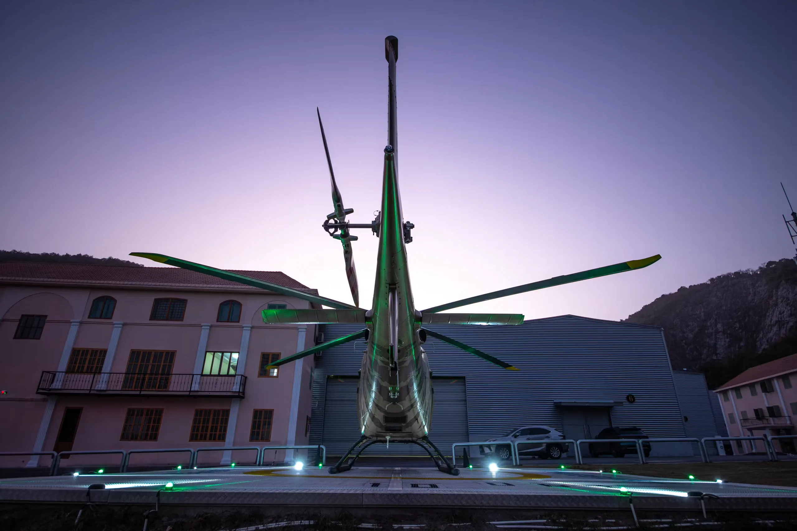 Rear view of a B-704A helicopter on a helipad.