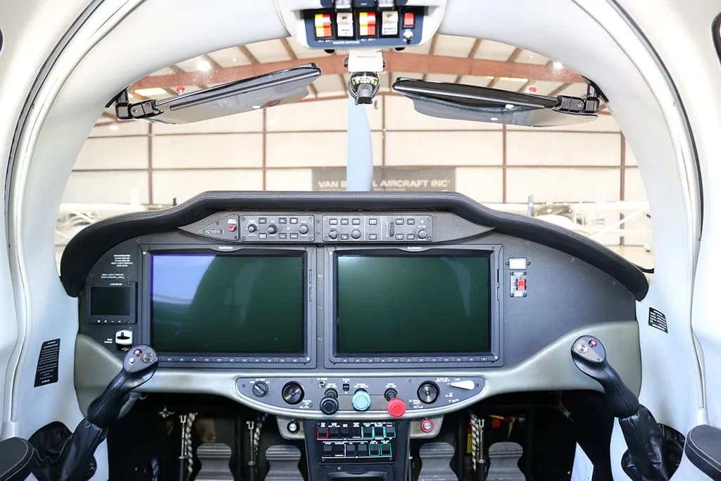 Cockpit view of a Cessna TTX aircraft showing the instrument panel with two large display screens and controls.