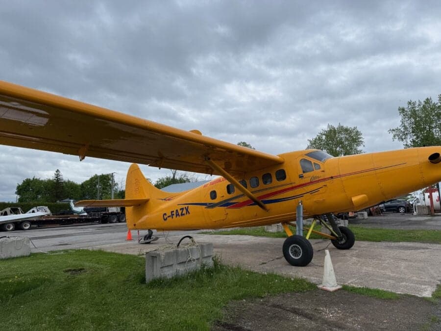 Yellow aircraft with floats parked on the ground.