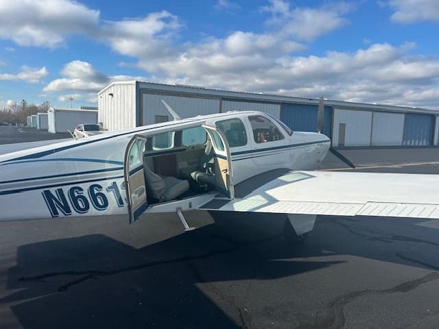 Beechcraft Bonanza N6613A with the door open, showing the interior.