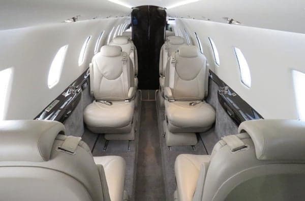 View of the aircraft's interior cabin with leather seats.