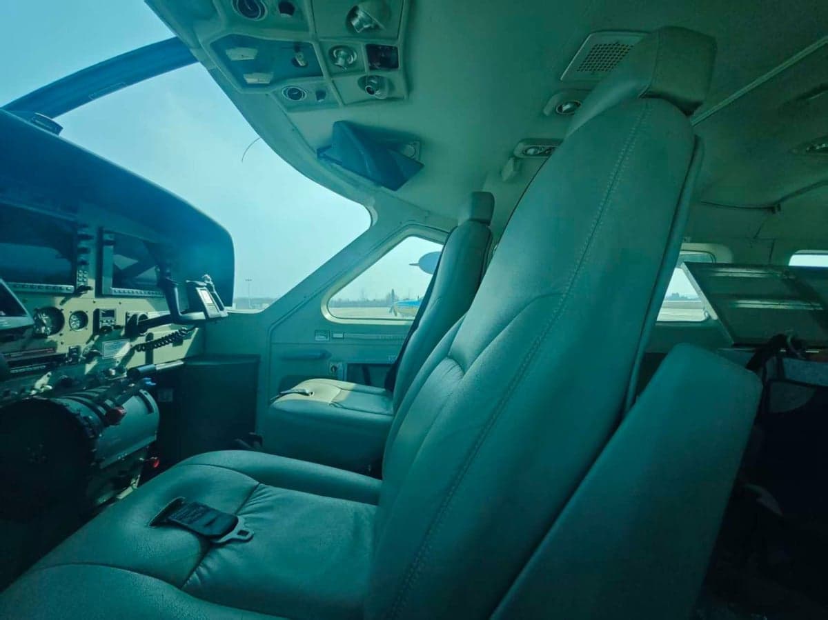 View of the cockpit with seats and instrument panel.
