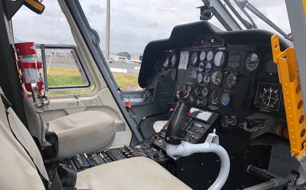 The helicopter's interior with seats and safety restraints.