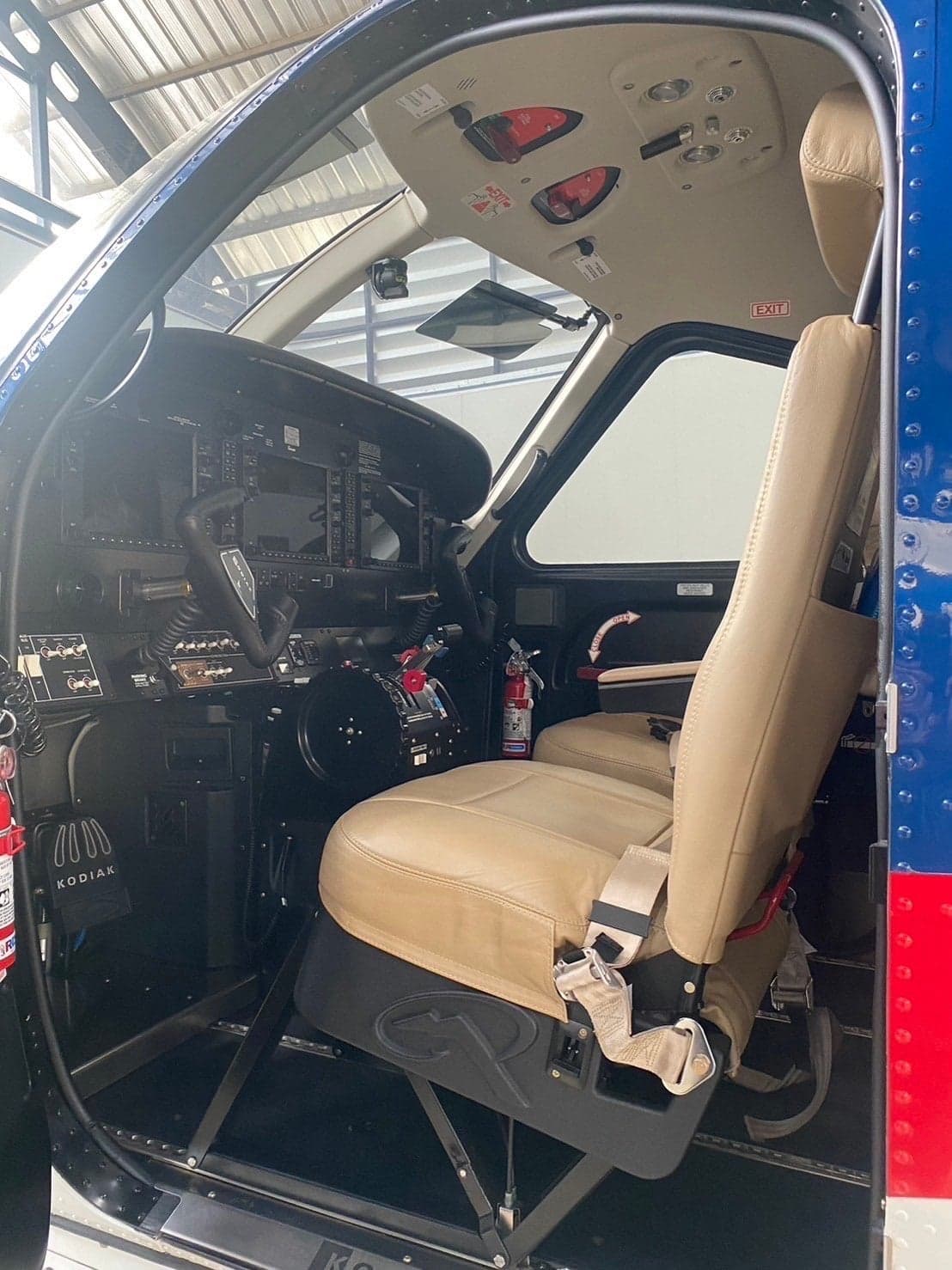 View of the cockpit of a Kodiak 100 with tan leather seats.