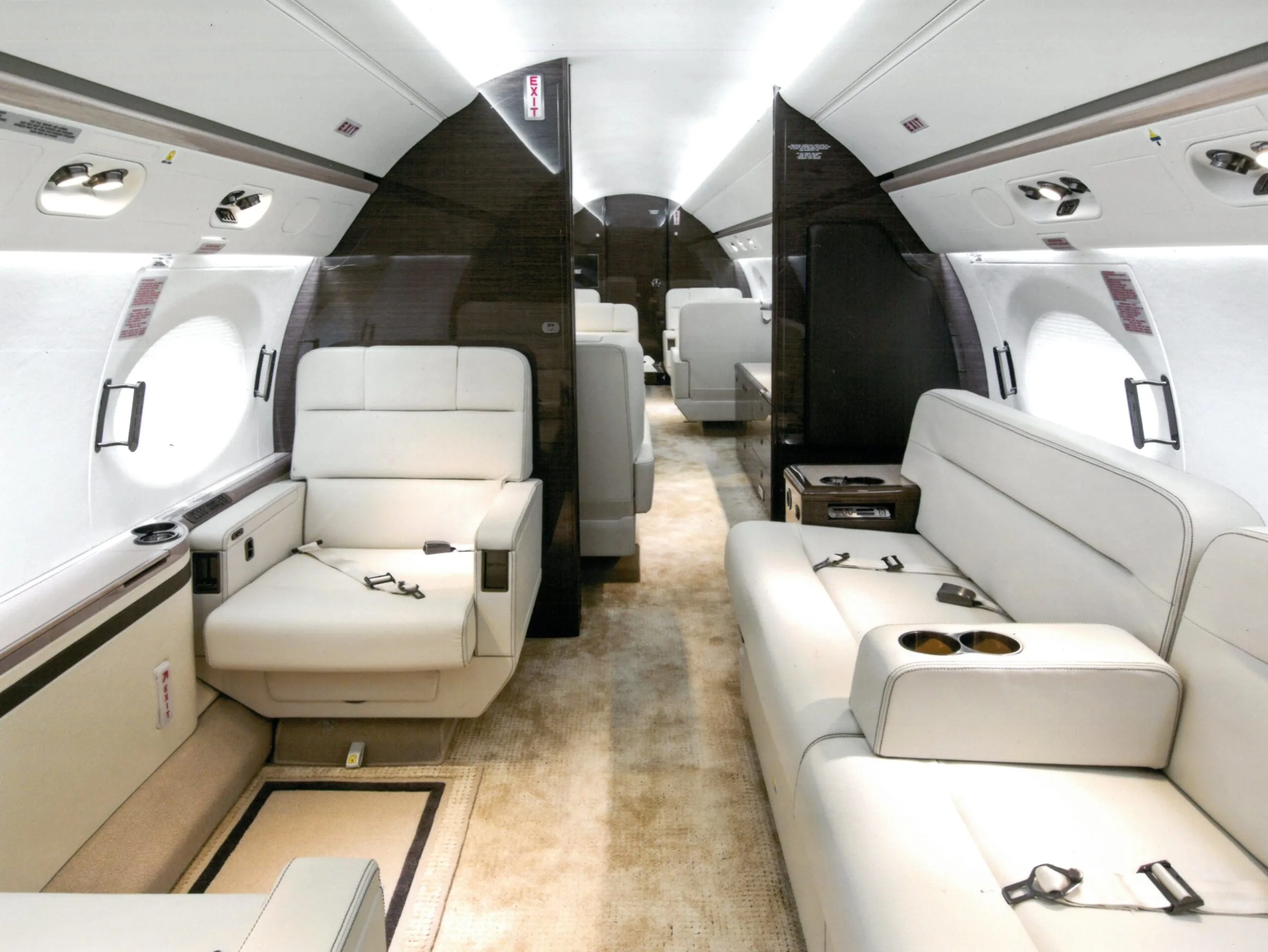View of the aircraft cabin with white leather seats.