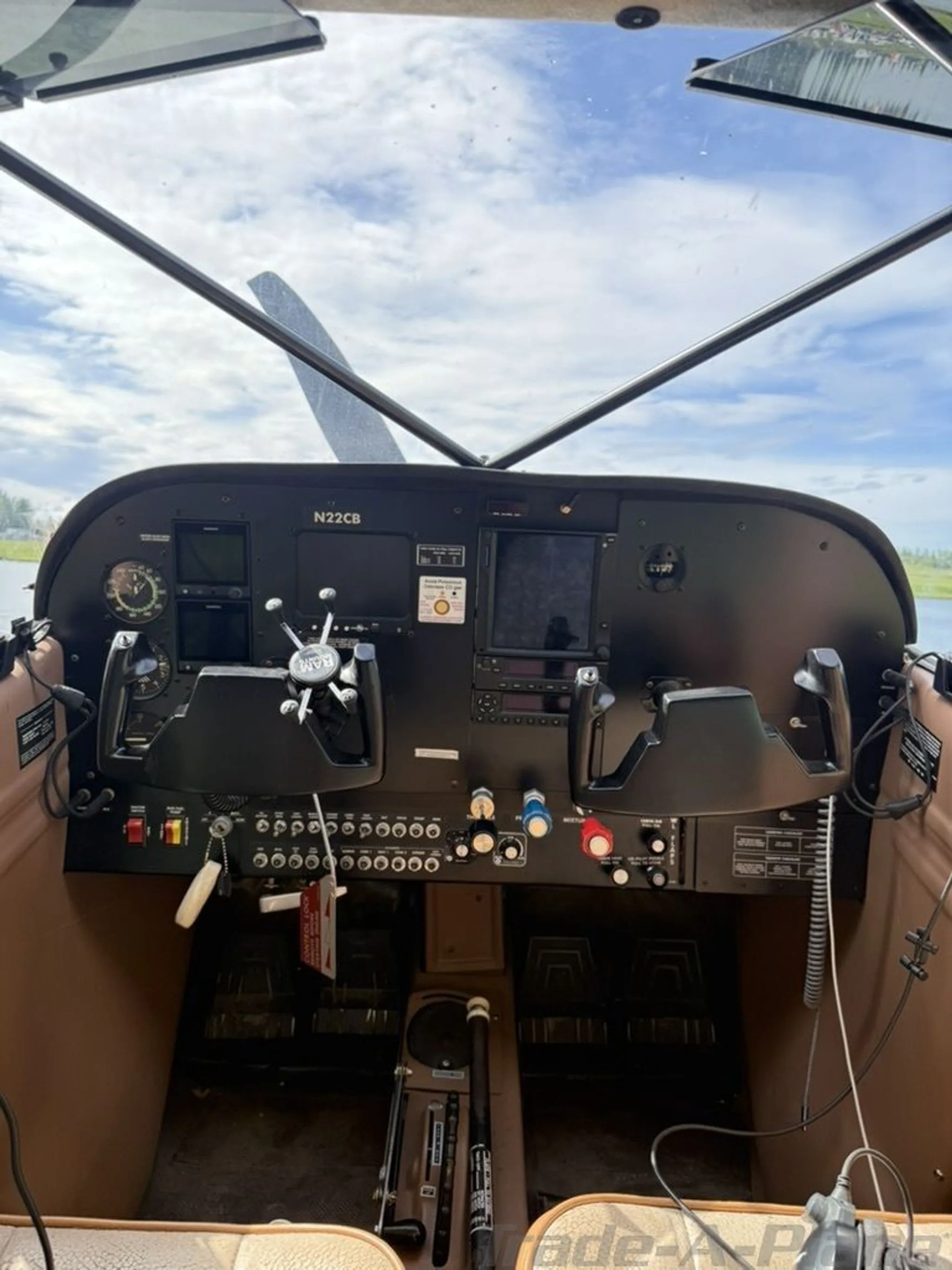 The cockpit of N22CB features a black instrument panel with modern avionics and dual yokes.
