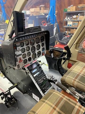 The cockpit of a Bell 206L-4 LongRanger helicopter with a full instrument panel.