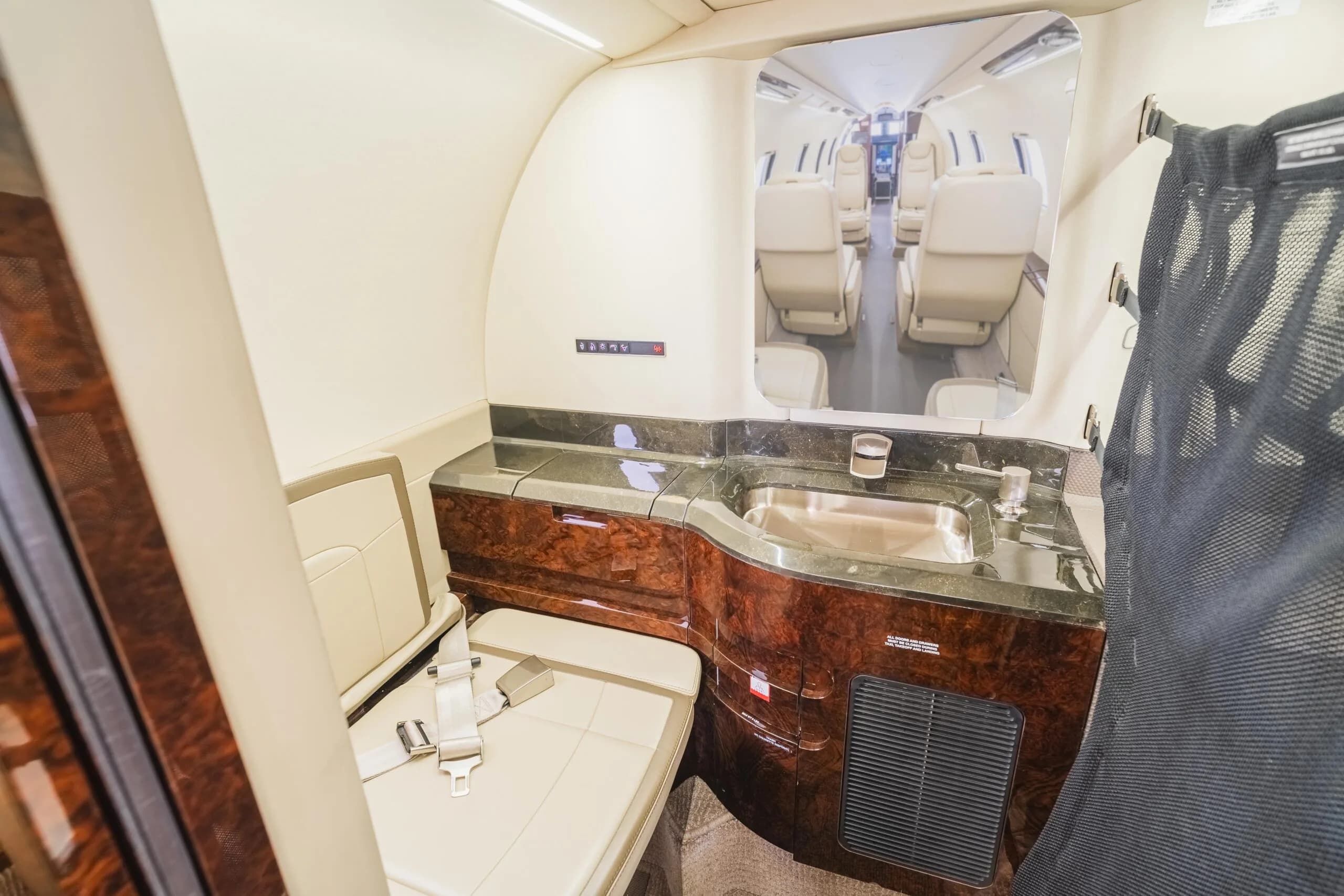 The aircraft's interior features a lavatory with a sink and seating.