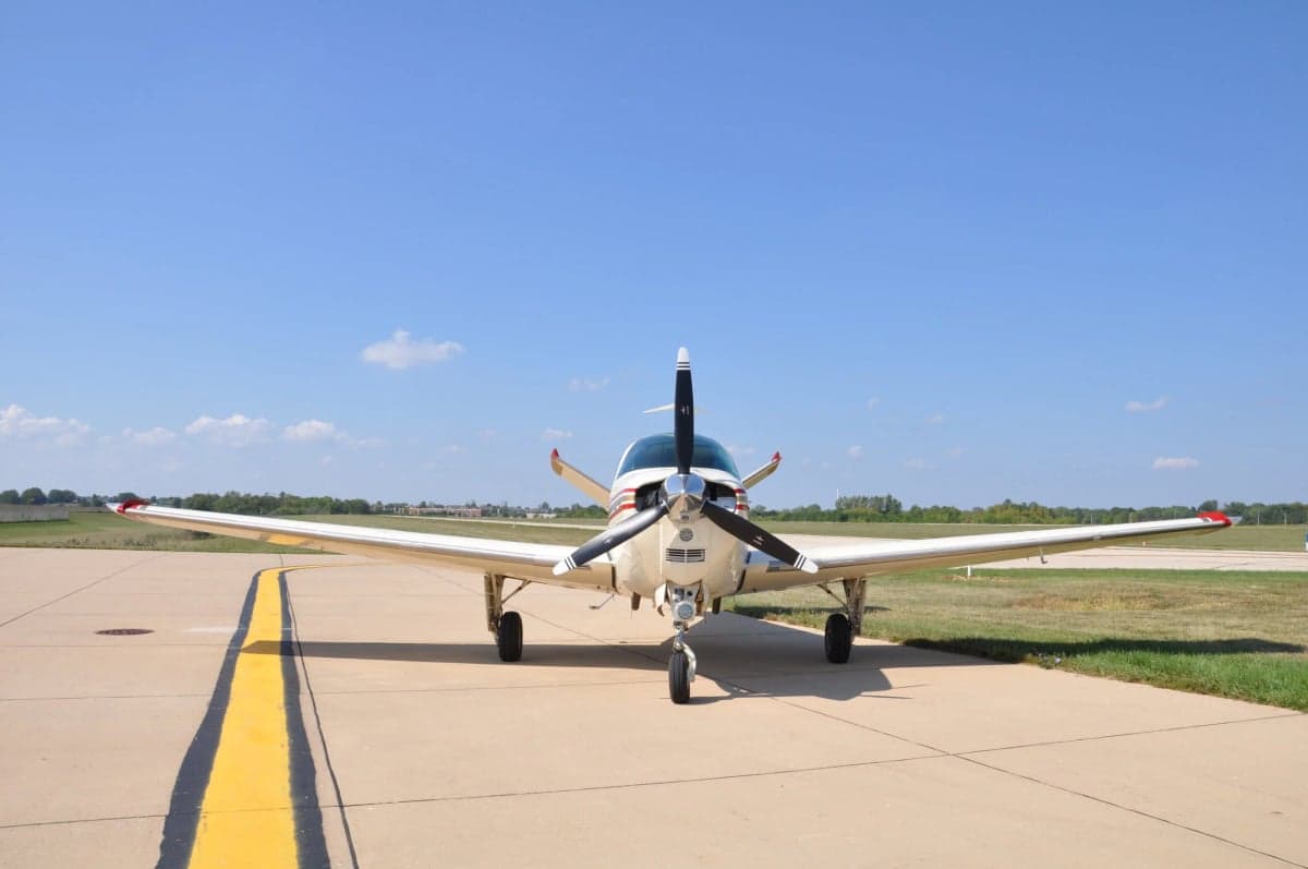 Front view of a Beechcraft Bonanza aircraft on the tarmac.