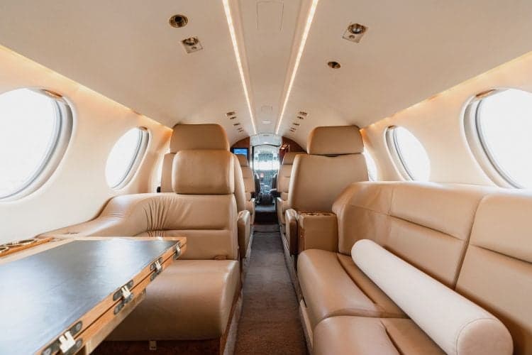 A view of the interior of a Falcon 50 aircraft, showing the seating arrangement and cabin details.