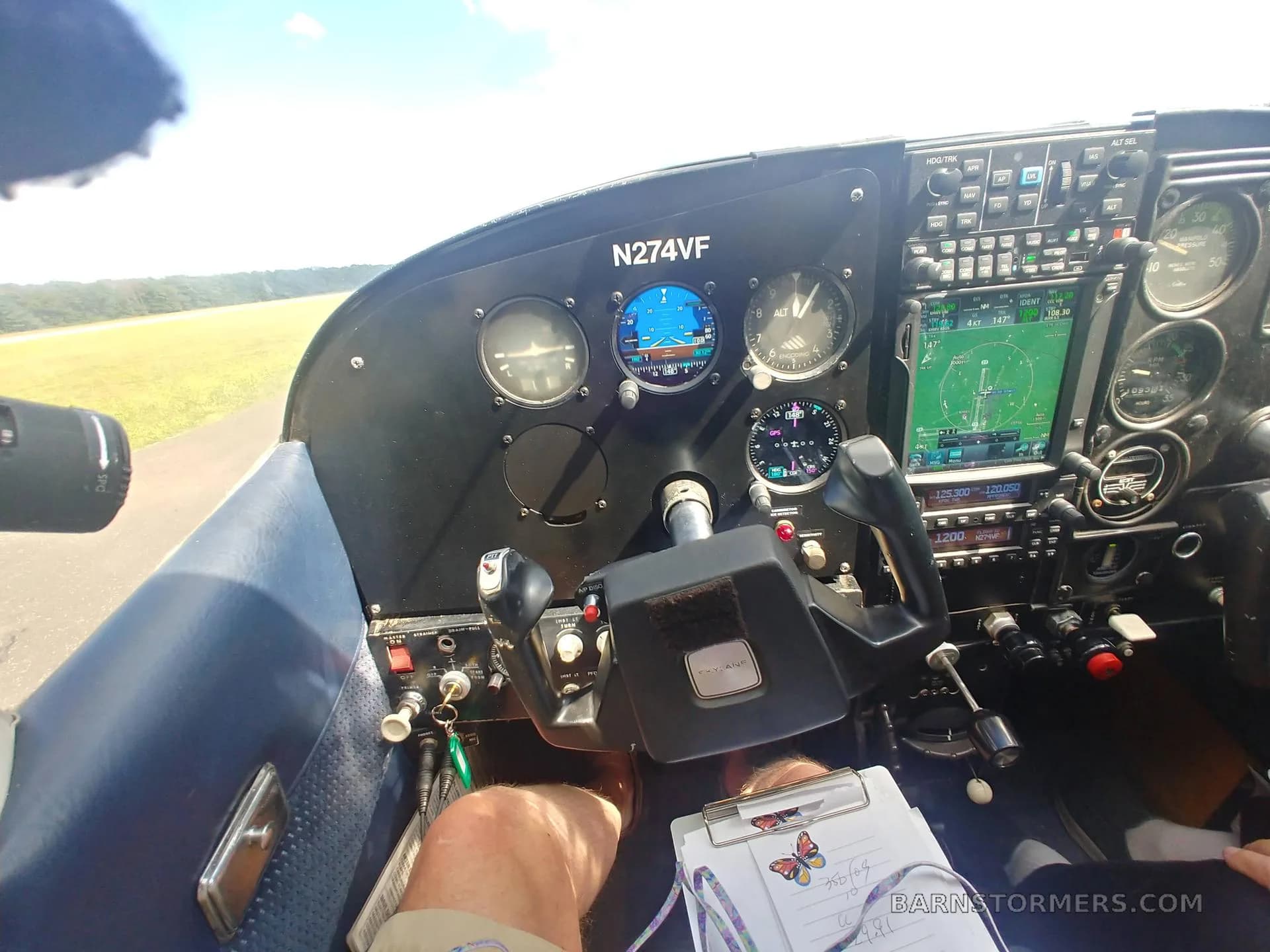 A view from the cockpit of a light aircraft (N274VF), showing the instrument panel, controls, and a runway ahead.