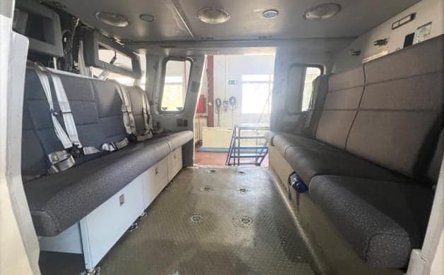 View of the helicopter's interior with seats and equipment.