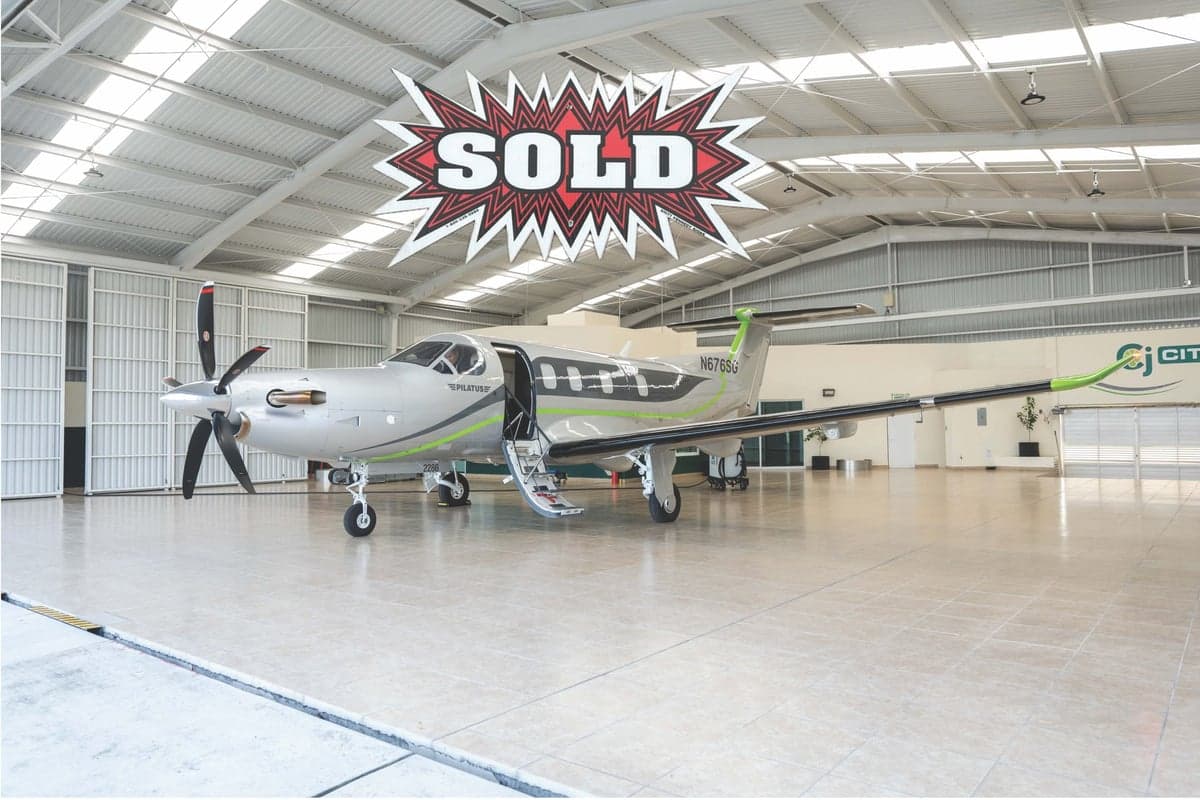 Pilatus PC-12 aircraft with registration N676SG parked in a hangar, with a "SOLD" graphic overlay.
