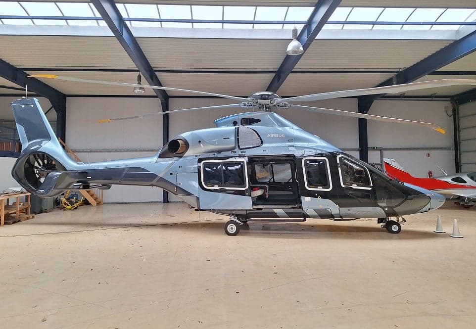 Airbus H160 helicopter parked inside a hangar.