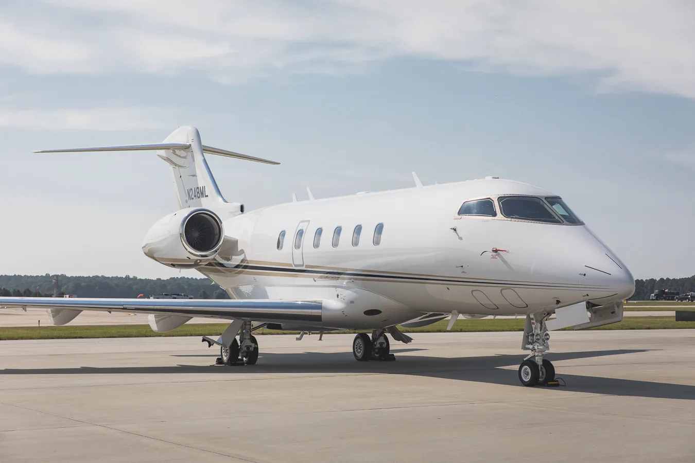 Front side view of the Challenger 300 aircraft with registration N248ML on the tarmac.