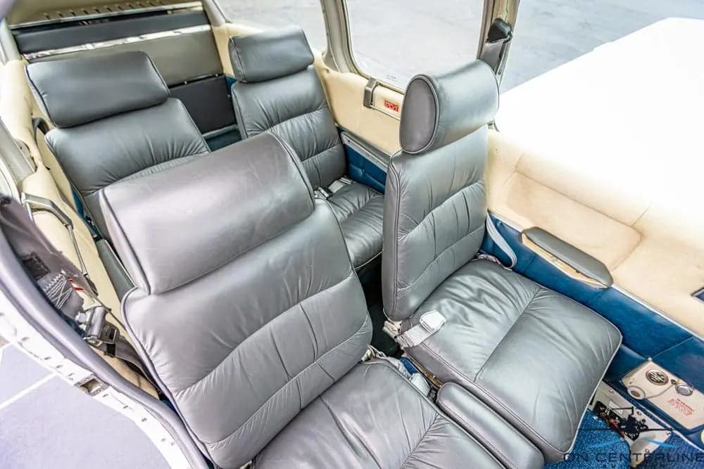 View of the gray leather seats in the cabin of the aircraft.