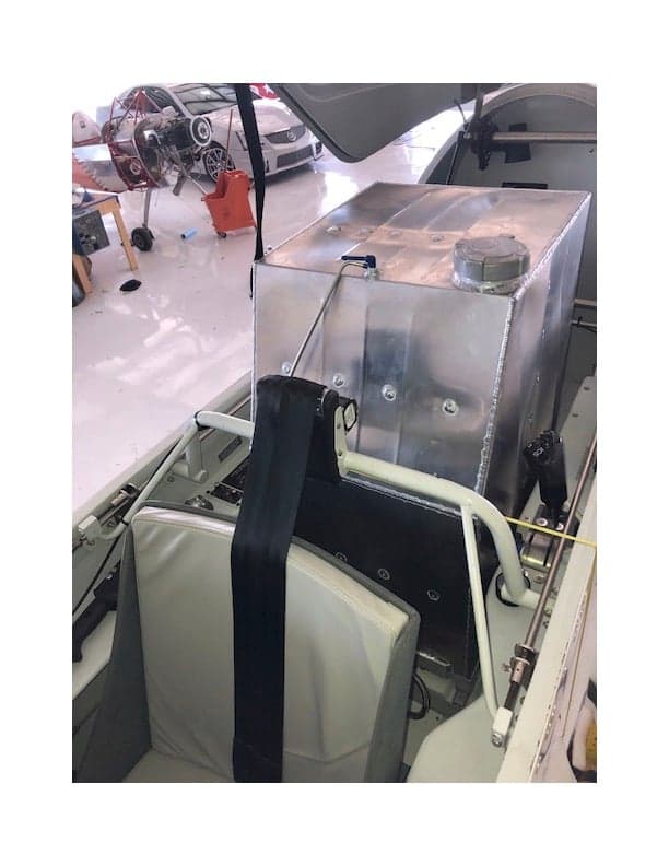 View of the aircraft's interior with a seat and a large metal box.