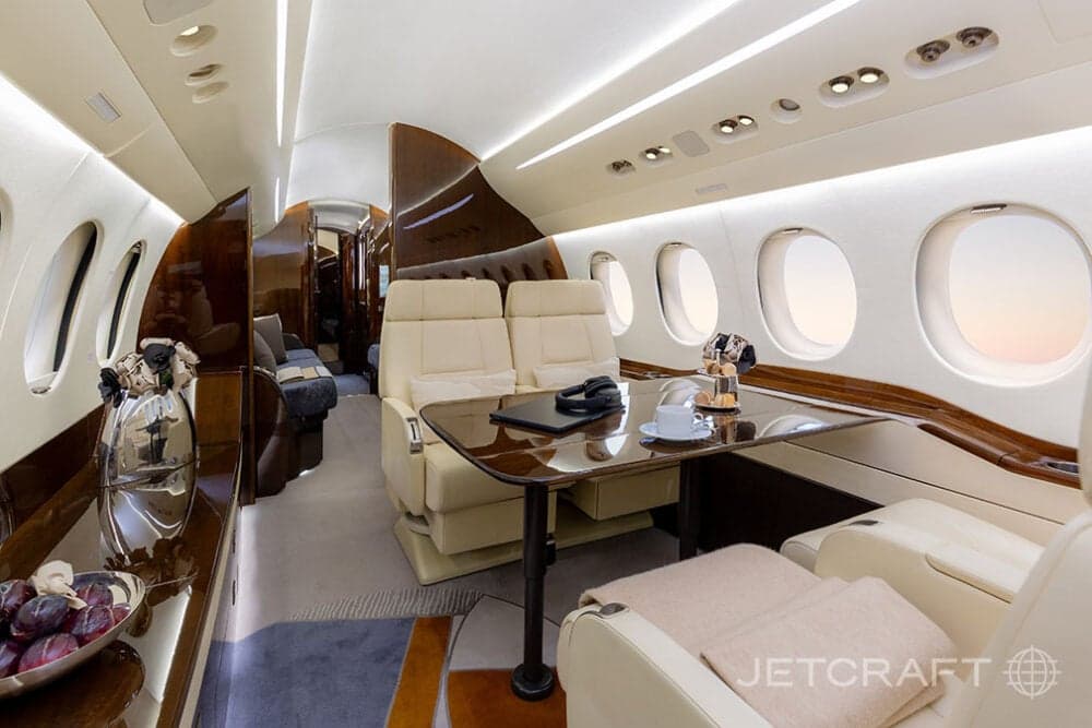 The aircraft's interior features a table with seating and amenities.