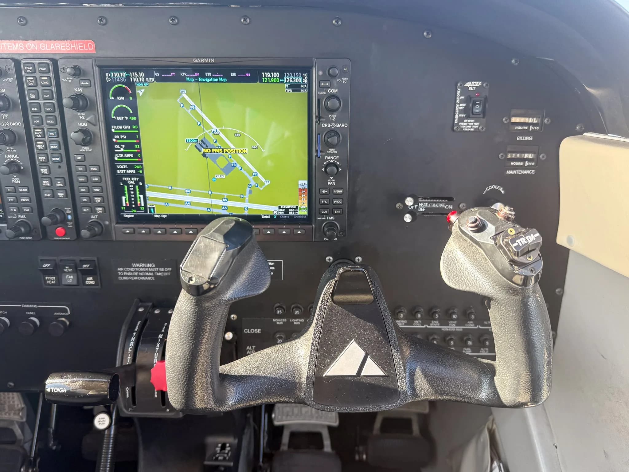 The cockpit of a Piper Archer TX, showing the Garmin G1000 NXi avionics and control yokes.