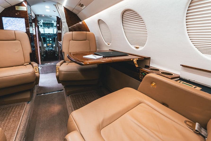 A view of the Falcon 7X cabin shows the seating arrangement and a glimpse of the cockpit.