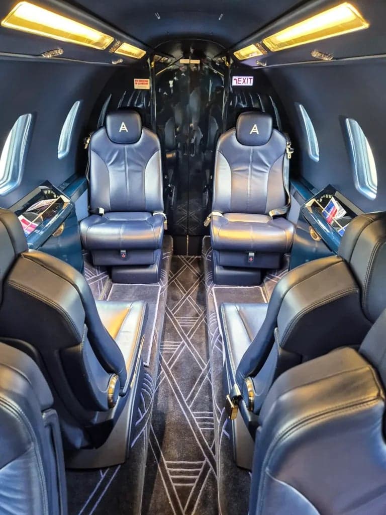 View of the aircraft's interior cabin with blue leather seats.