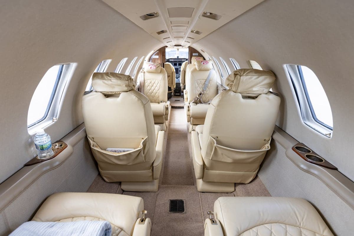 The interior of a Cessna Citation CJ3 with cream leather seats.