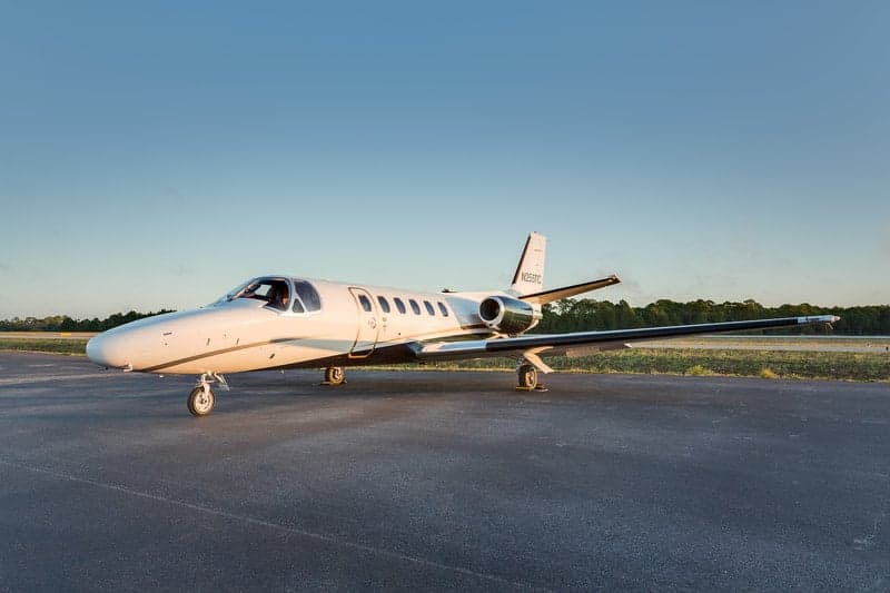 A side view of the N255TC aircraft on the tarmac.