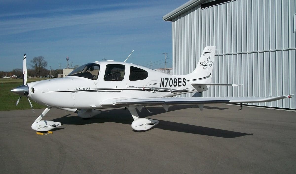 A Cirrus SR22T with registration N708ES is parked on the tarmac.
