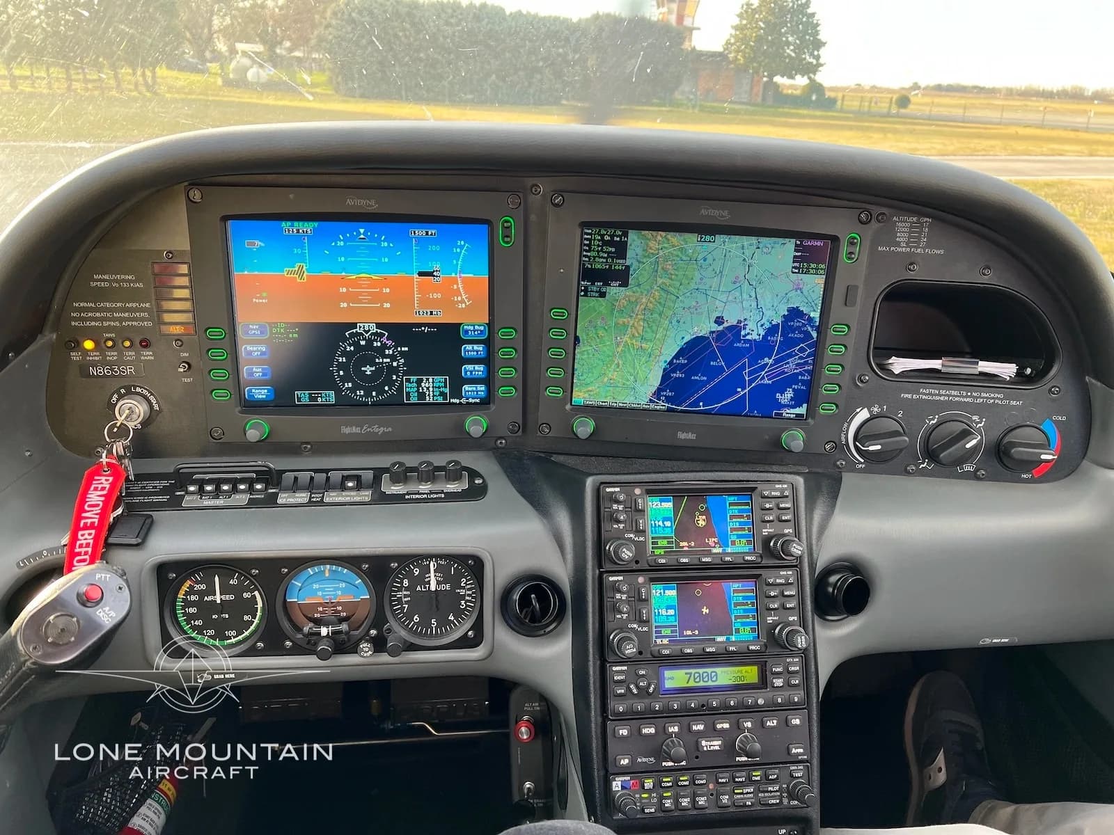 The instrument panel of a Cirrus SR22 aircraft, featuring two large display screens and various gauges.