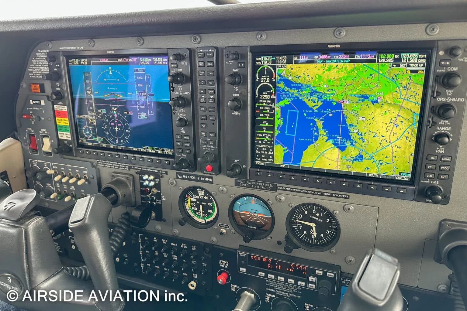 A close-up view of an aircraft cockpit's Garmin G1000 displays showing flight instruments and a navigation map.