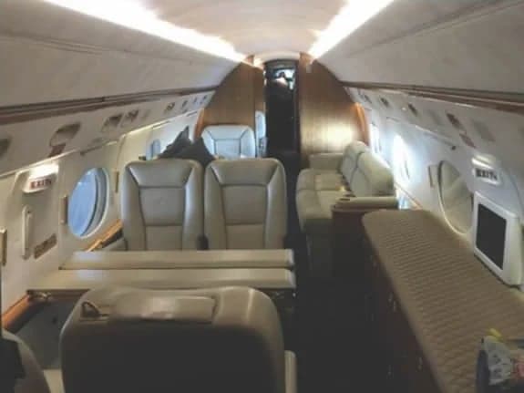 View of the aircraft's interior cabin with leather seats.