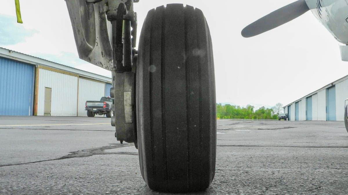 Close up of the landing gear and tire of the Beechcraft Bonanza.