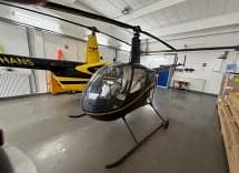 Robinson R44 helicopter in a hangar.
