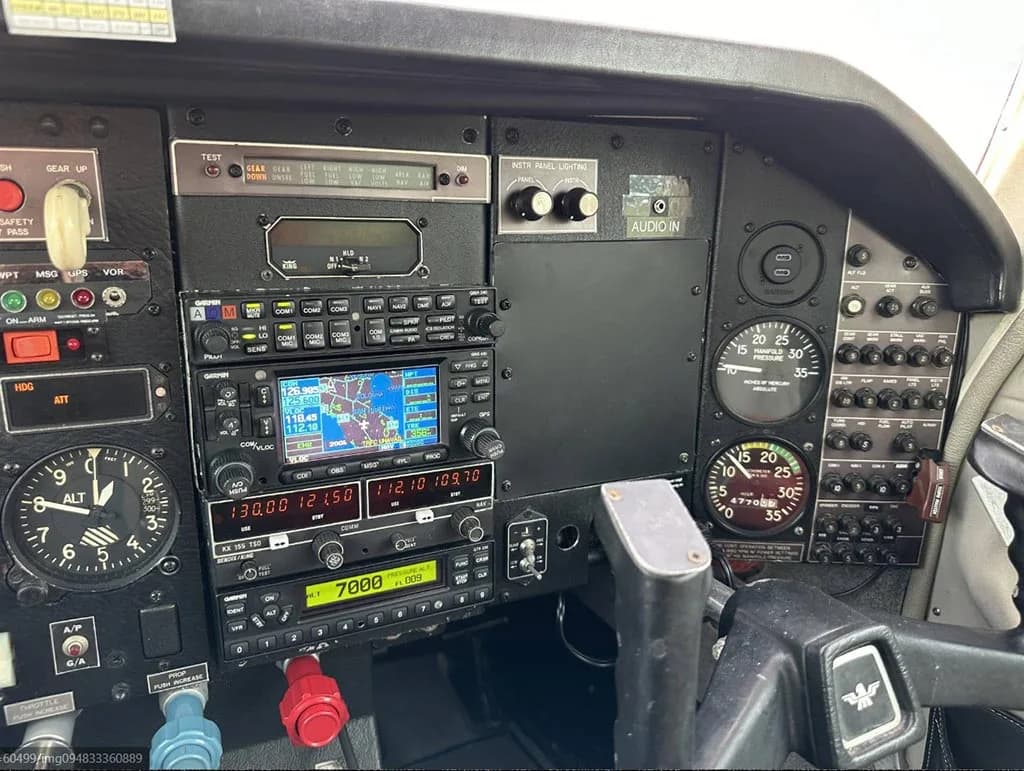 A close-up view of the Mooney M20J's avionics stack, including Garmin GPS/COM units.