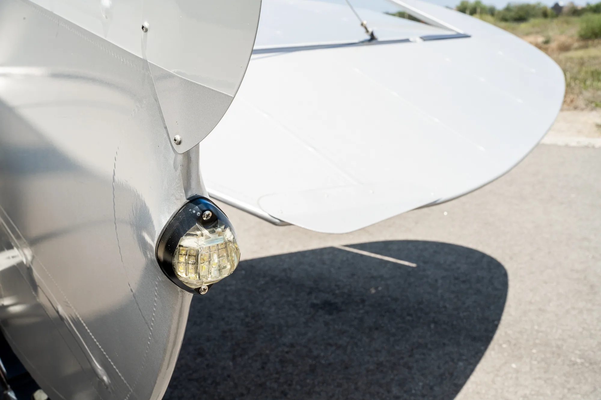 Close up of the tail light on a white and gray CubCrafters XCub aircraft.