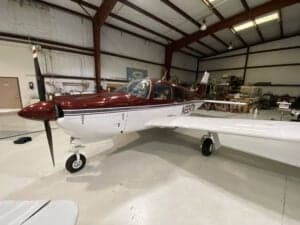 N2247M is shown in a hangar with a red and white paint scheme.