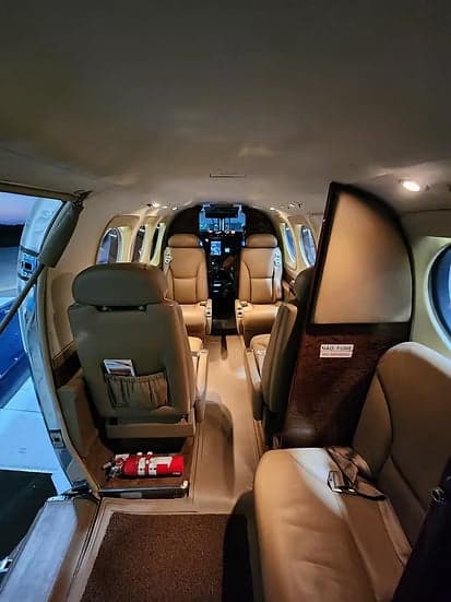 Interior view of the aircraft cabin showing the seats and cockpit.