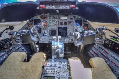 The cockpit of the Learjet 31A features a full instrument panel and sheepskin seat covers.