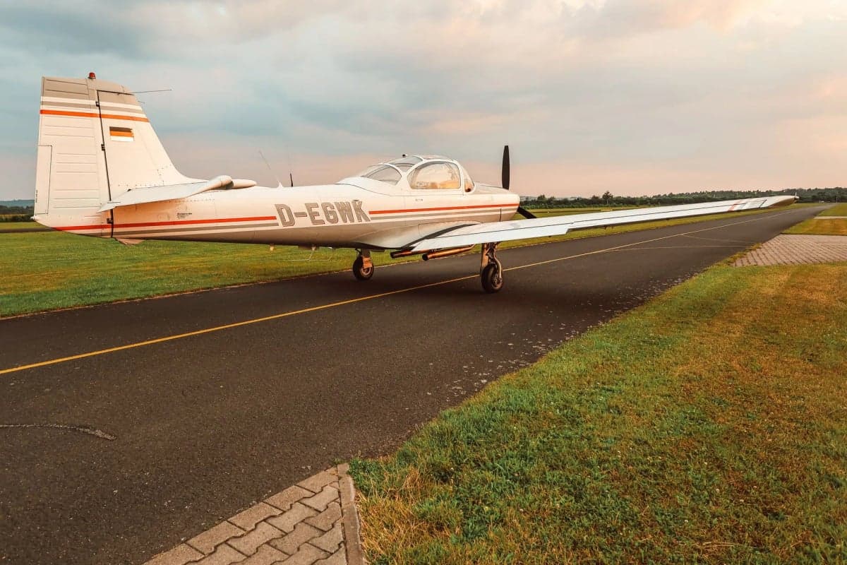The D-EGWK aircraft is parked on the runway with a gray and white paint scheme.