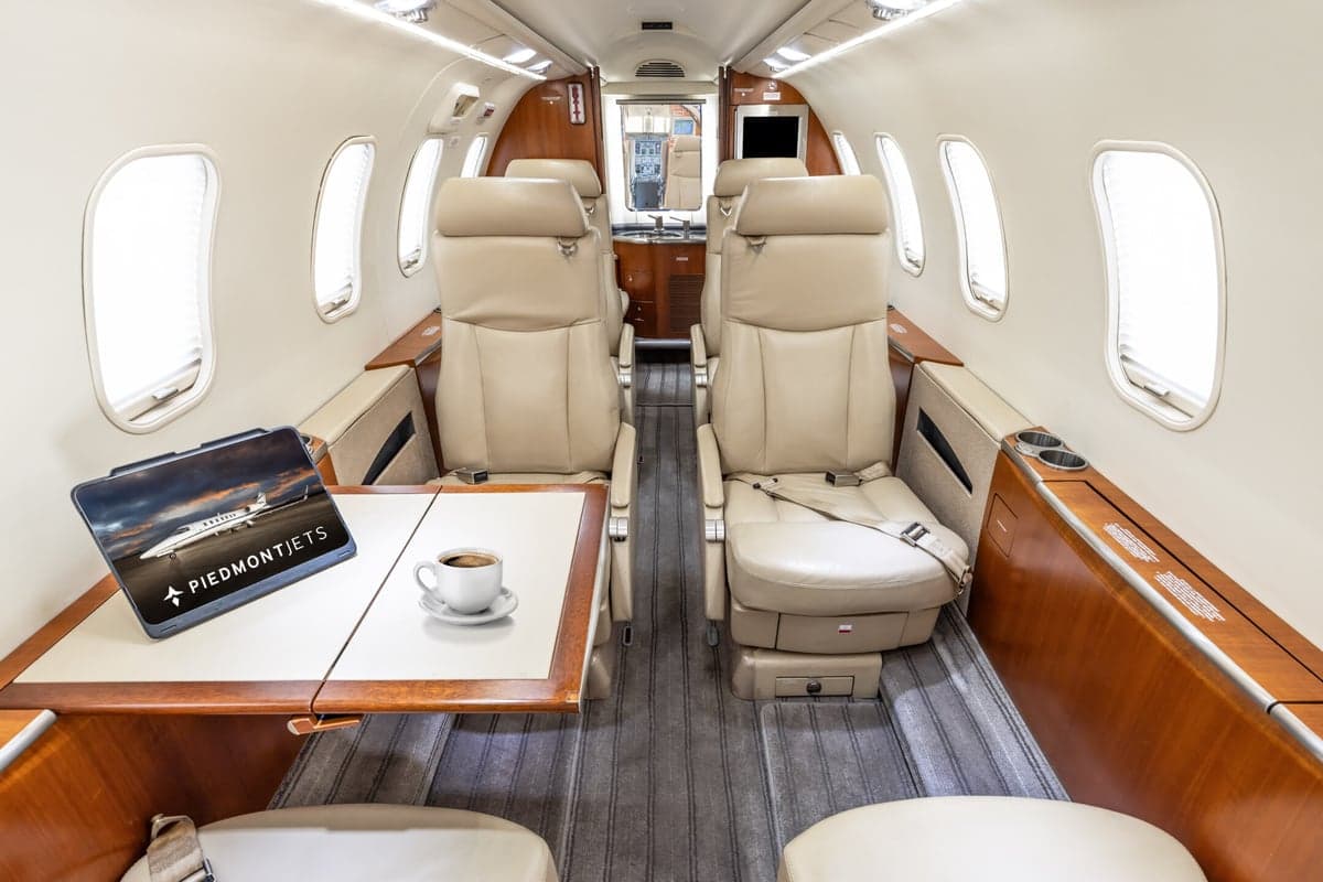 View of the interior cabin of a Learjet 45XR aircraft with a table and tablet.