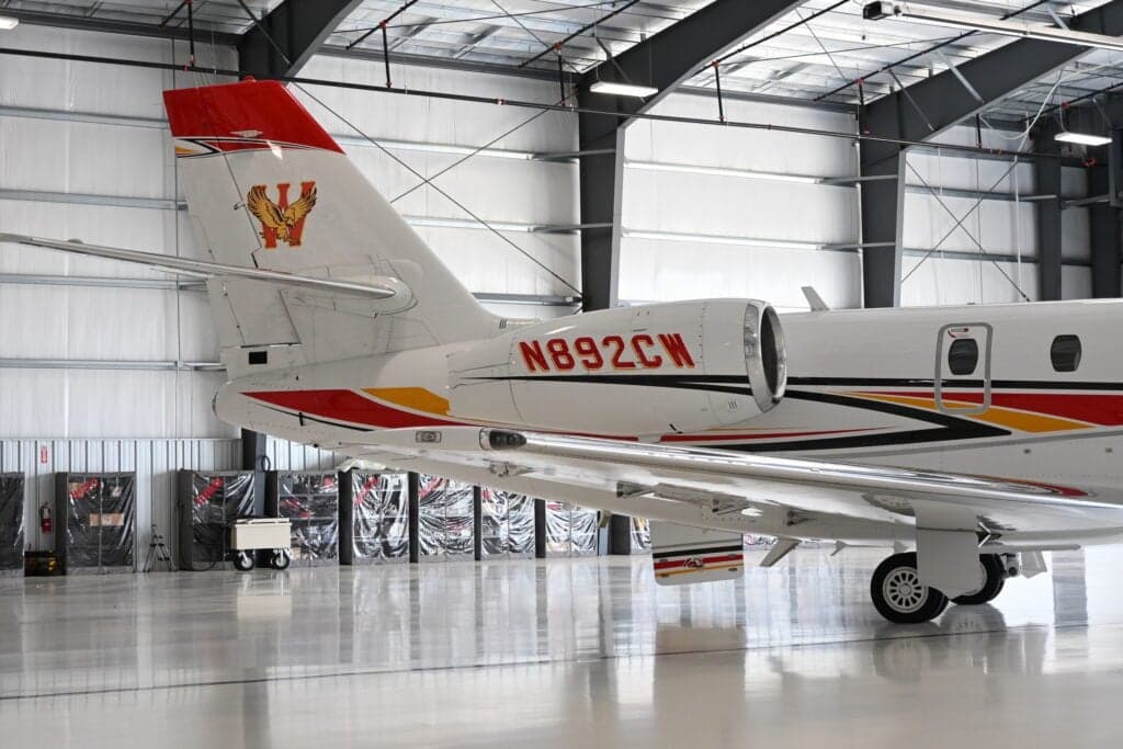 Tail section of a Citation Sovereign aircraft with tail number N892CW in a hangar.