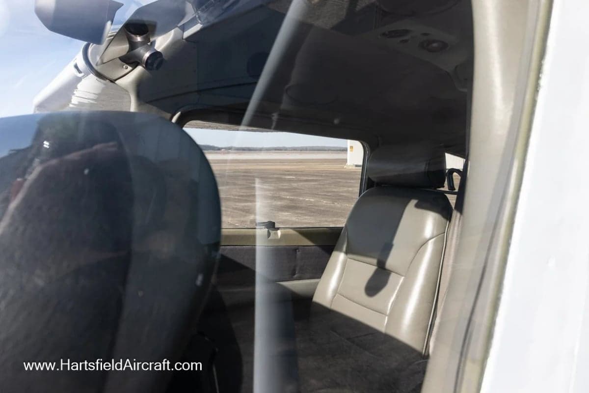 View of the interior seats of an aircraft through the window.