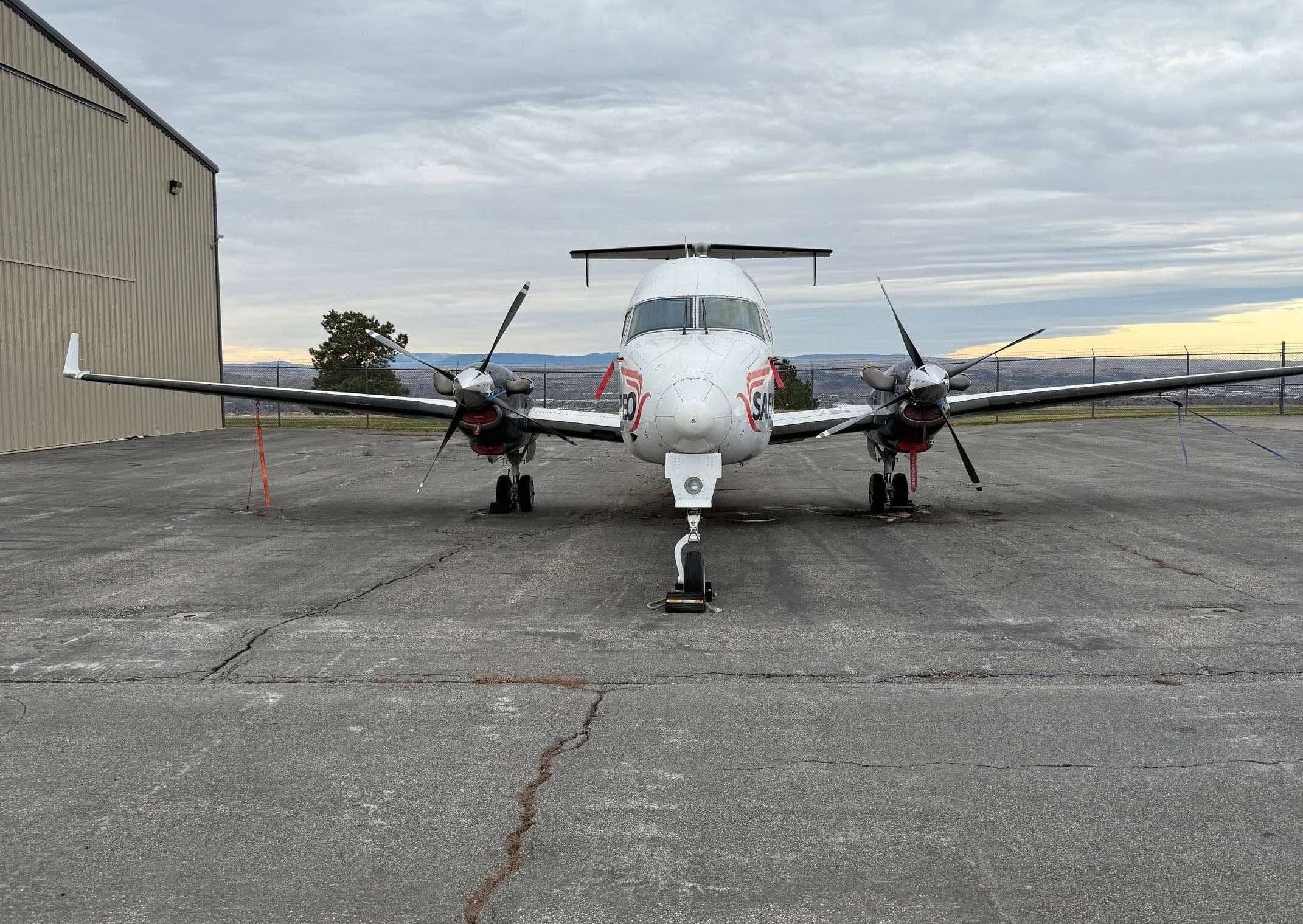 A front view of a Beechcraft 1900C with SAEREO livery parked on the tarmac.