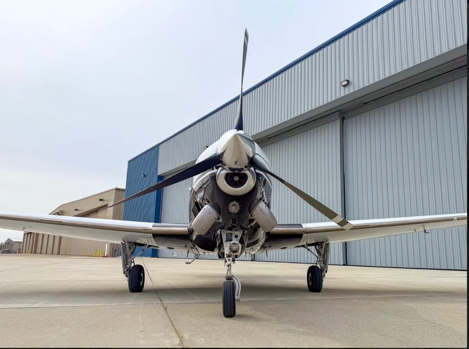 A close-up head-on view of the propeller and nose of the Beechcraft Baron N157BA.