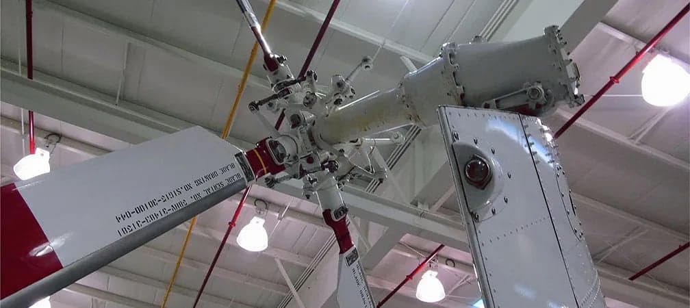 Close-up of the rotor head and blades of a Sikorsky S-58 helicopter.
